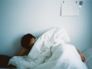 Calming cover illustration for Sleep hygiene for insomnia showing a dim lamp, notebook, mug, and early‑dawn window