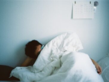Calming cover illustration for Sleep hygiene for insomnia showing a dim lamp, notebook, mug, and early‑dawn window