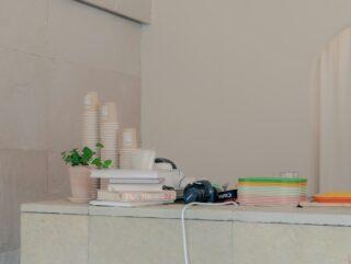Cover image for skin maintenance routine with simple bottles, towel, water glass, and sunrise/moon icons