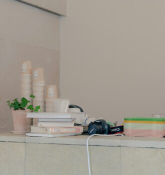 Cover image for skin maintenance routine with simple bottles, towel, water glass, and sunrise/moon icons